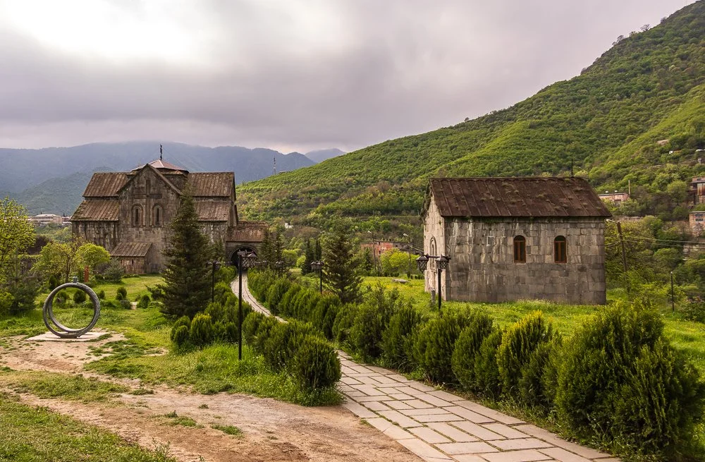   Akhtala Monastery  began as a defensive fortress before becoming a religious centre, set on a plateau above a river and partially surrounded by old fortress walls. Its 13th-century frescoes cover much of the interior, something rare in Armenian chu