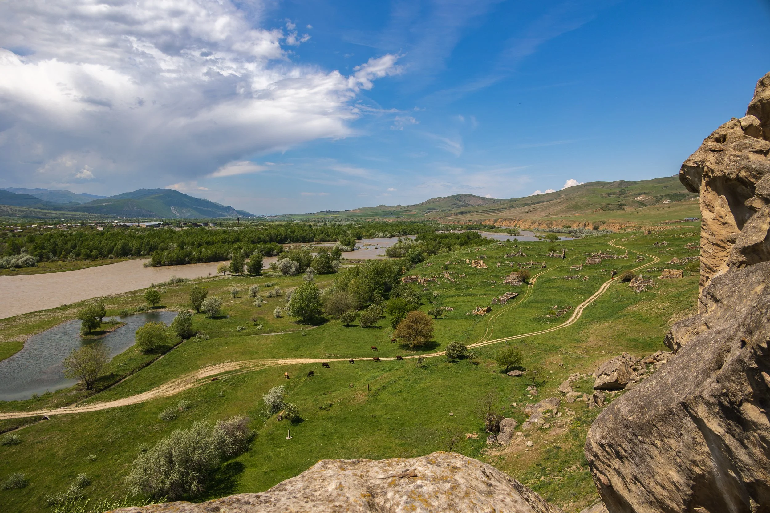 The ruins of the newer, abandoned village of Kvakhvreli are visible tucked within the scrubland below the cliff face.  