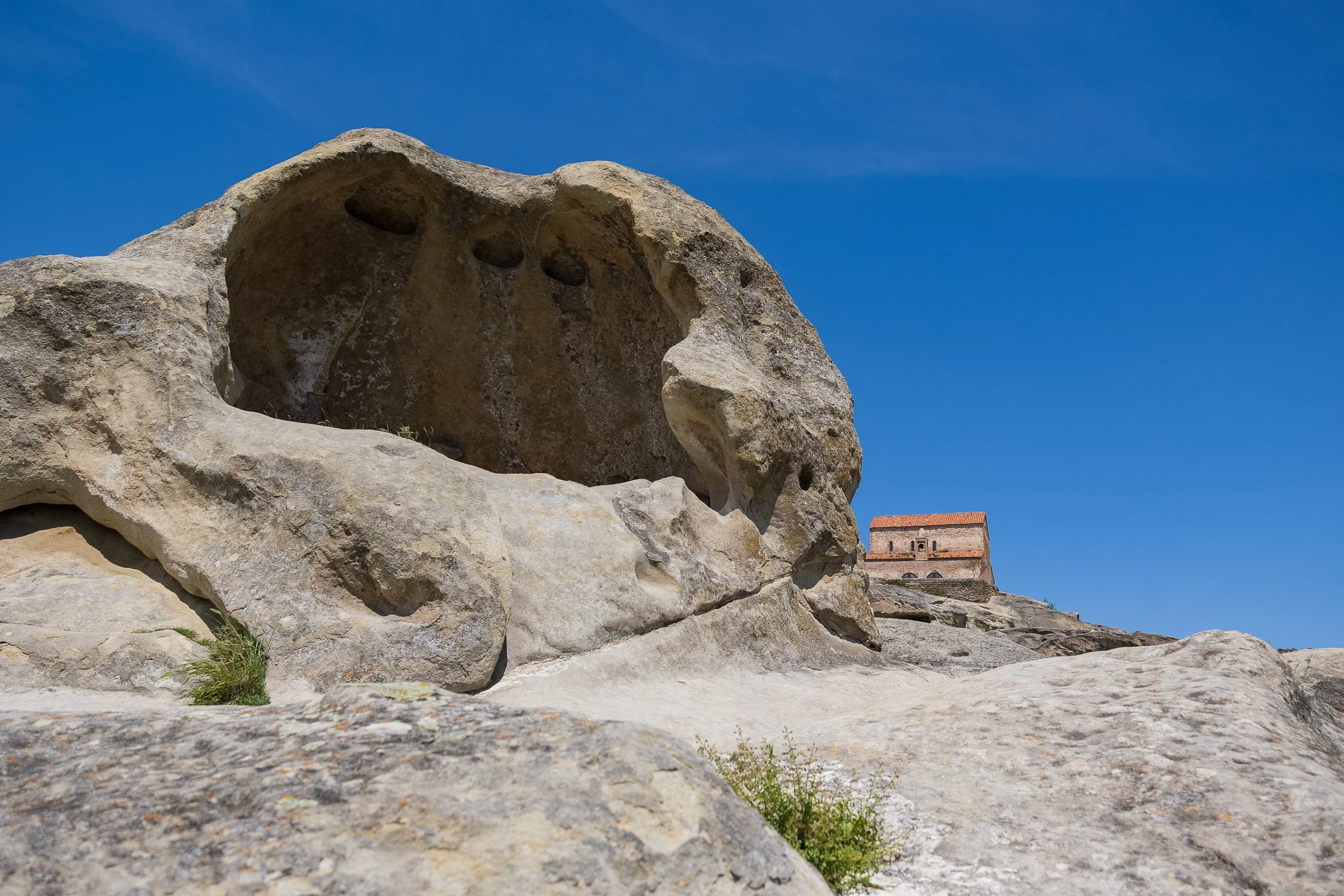 Near the top of the hill sits the 10th-century Uplistsuli Church, a triple-church basilica built directly over the ruins of a former pagan sun temple. 