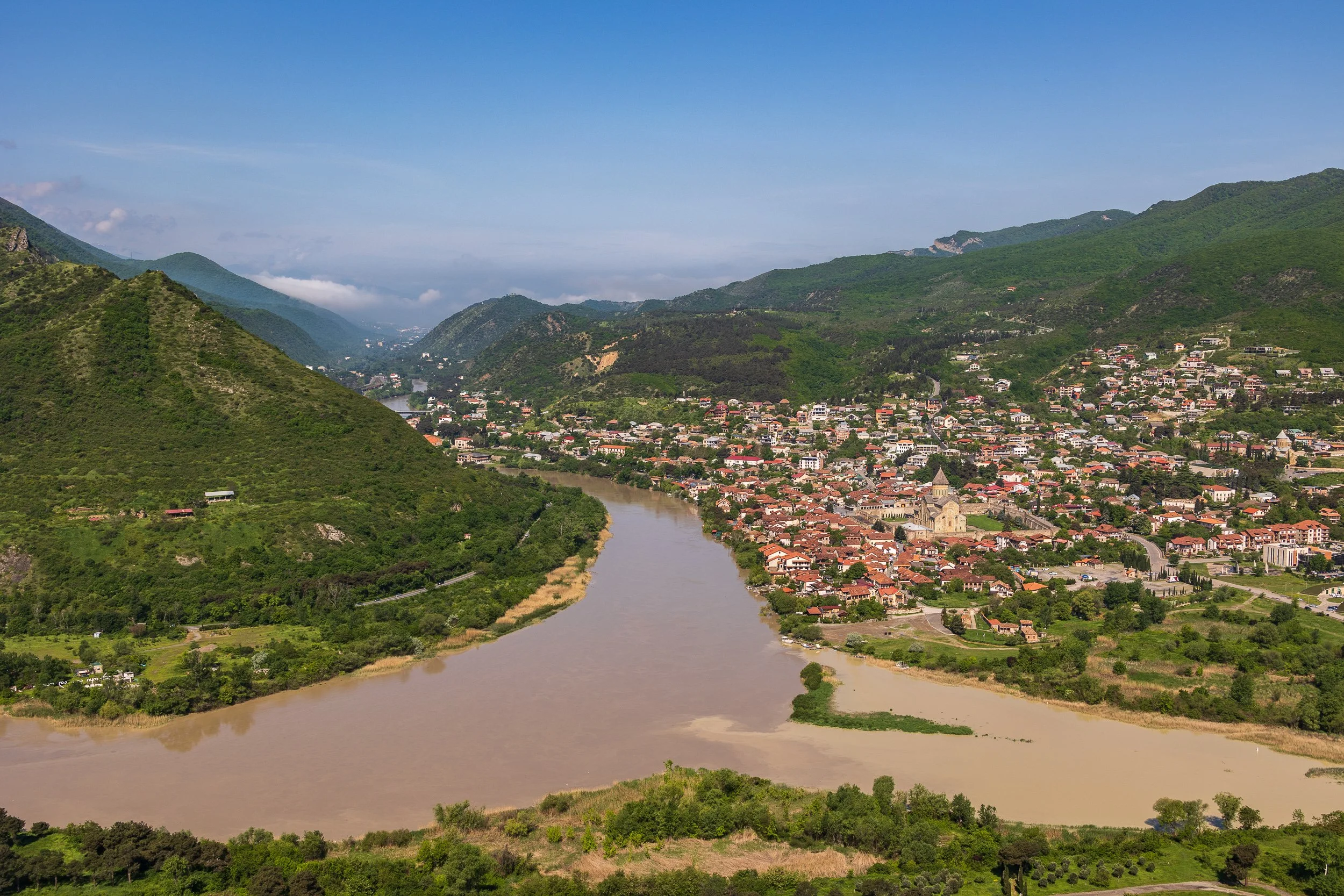  Mtskheta (the town, from Jvari) - red rooftops crowding the riverbank, the cathedral and its walls at the centre. 