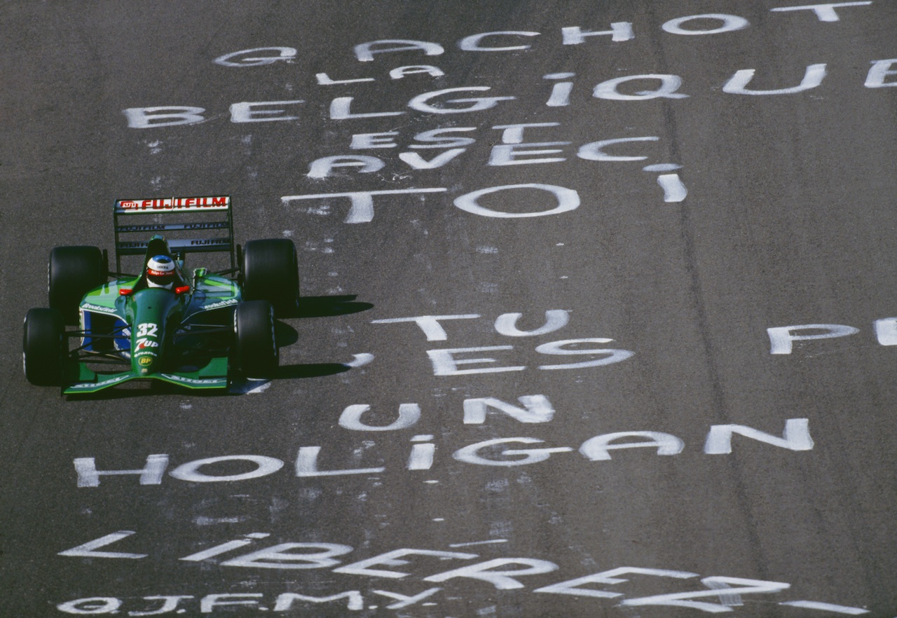 Michael Schumacher flies over pro-Gachot graffiti left by disgruntled Belgian fans.