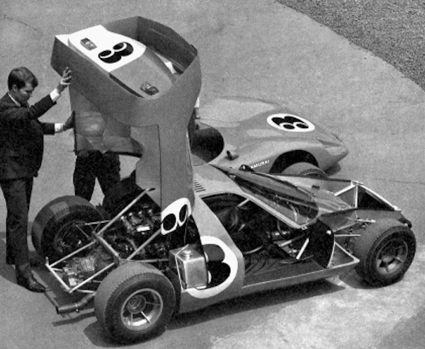 Pete Brock demonstrating the large "clam shell" engine cover.