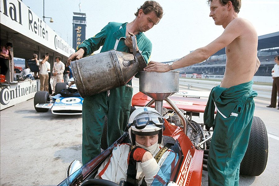 John Surtees receiving a fresh batch of fuel. Hockenheim, 1970 German Grand Prix.