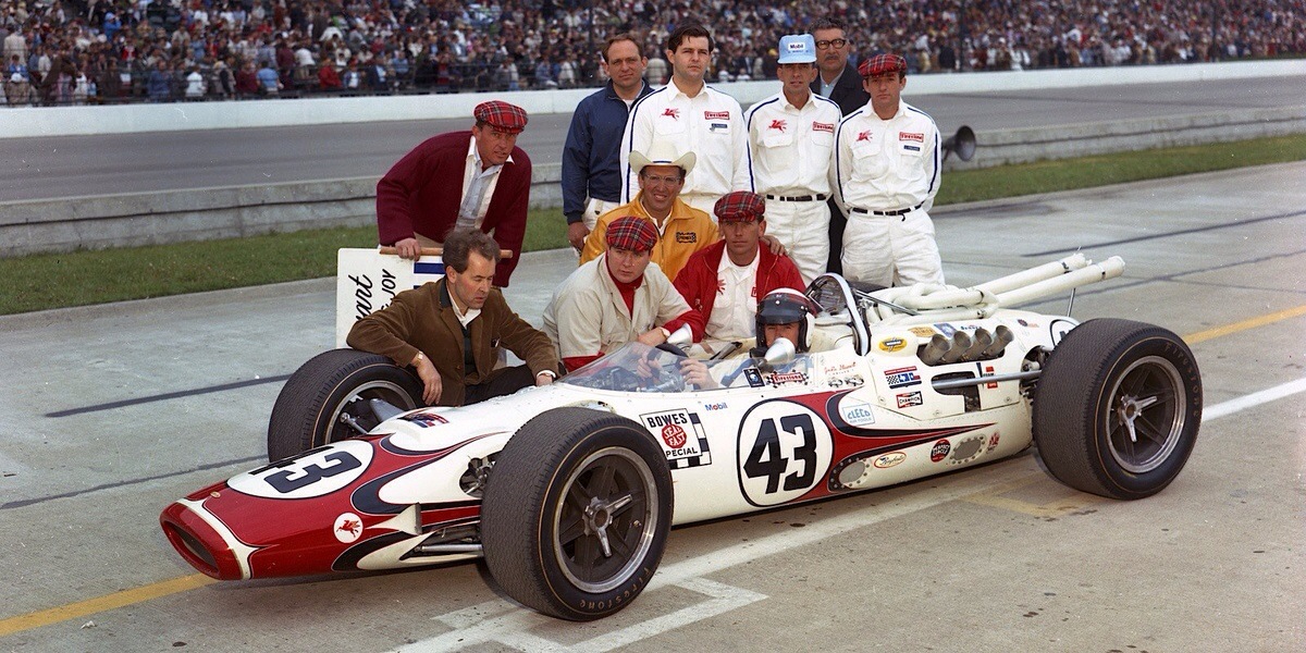 The team sporting tartan caps in honor of Jackie Stewart's Scottish heritage.