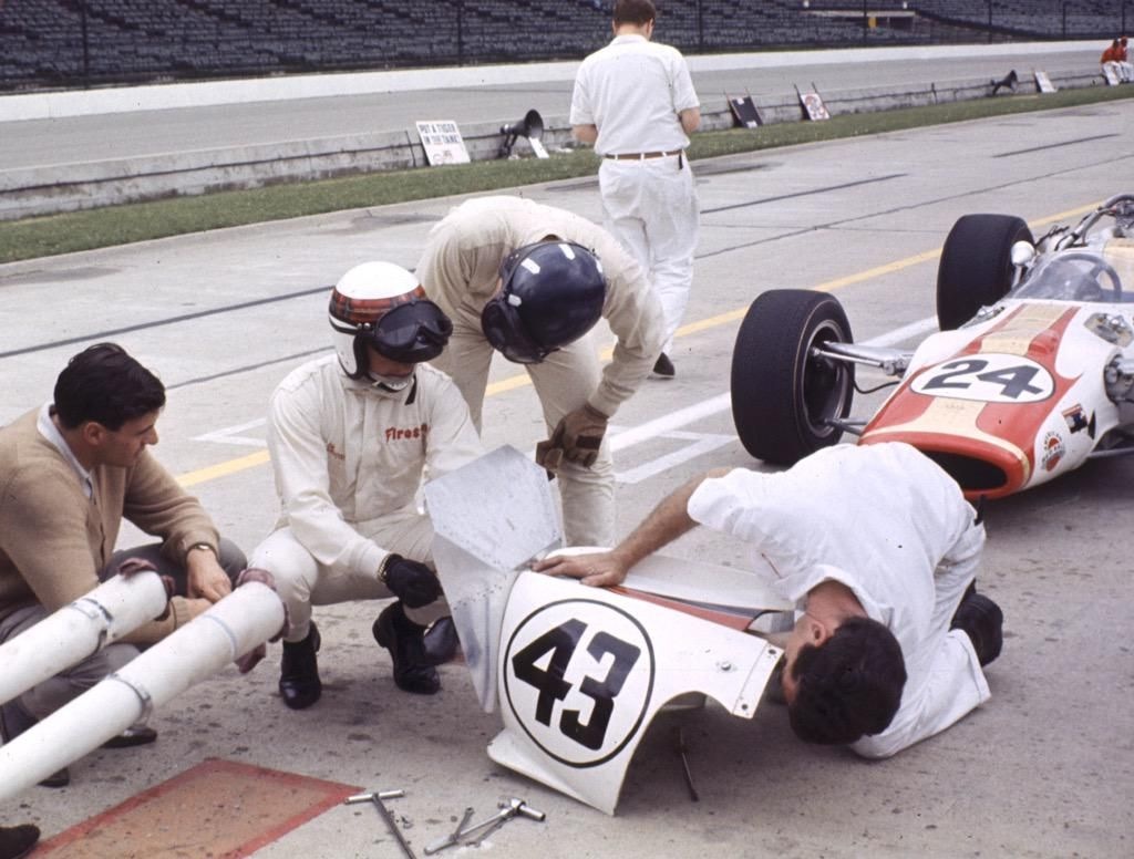 Jackie Stewart and Graham Hill discussing matters in the pits, Indianapolis 1966.