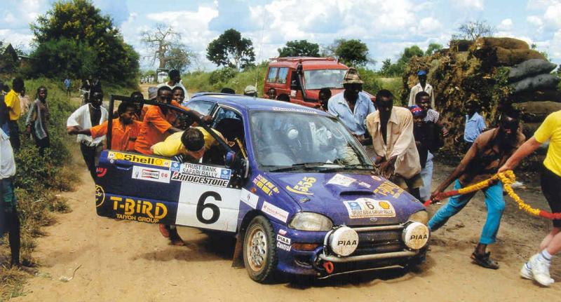 McRae and a helpful band of locals pushing the car to the finish in the Kenyan heat.