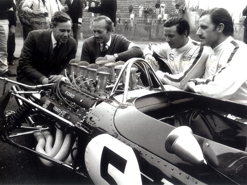 Cosworth's Keith Duckworth, Colin Chapman, Jim Clark and Graham Hill admiring the DFV, Zandvoort 1967.