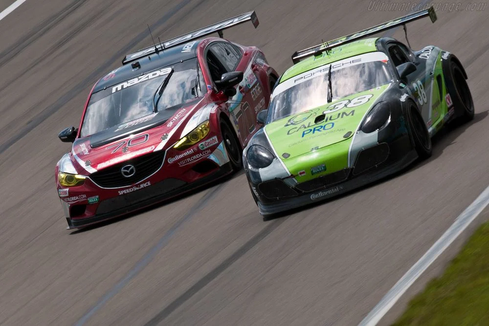 Mazdaspeed battling its archnemesis, the BGB Motorsports Porsche Cayman GX.