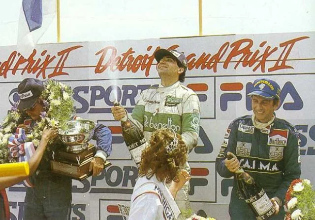 Michele Alboreto celebrating in Detroit with Keke Rosberg (left) and John Watson (right).