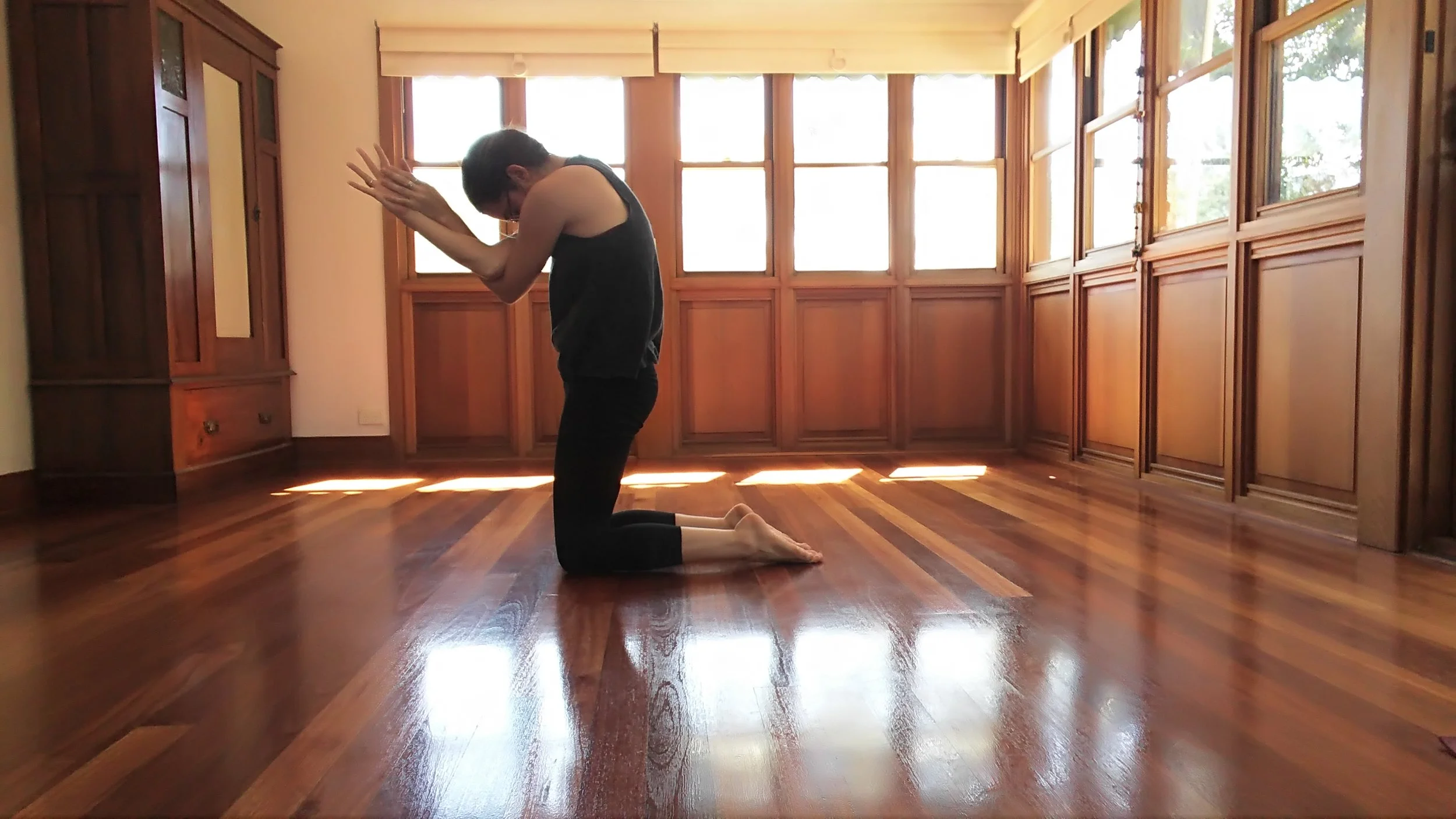 Cross left arm under the right. Twist and push forearms together to create resistance in the arms. Allow upper back to bend forward. Repeat on other side, twisting right arm underneath the left.
