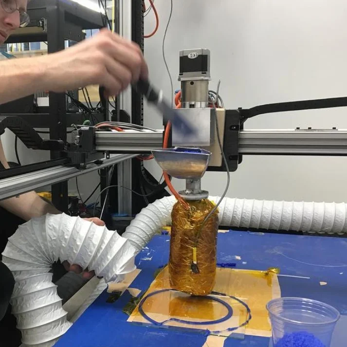 Early version of the V1 pellet extruder. This design was limiting and became the bottleneck for printing, the low torque and slow melt rate limited the design, prototyping, and producing of objects.