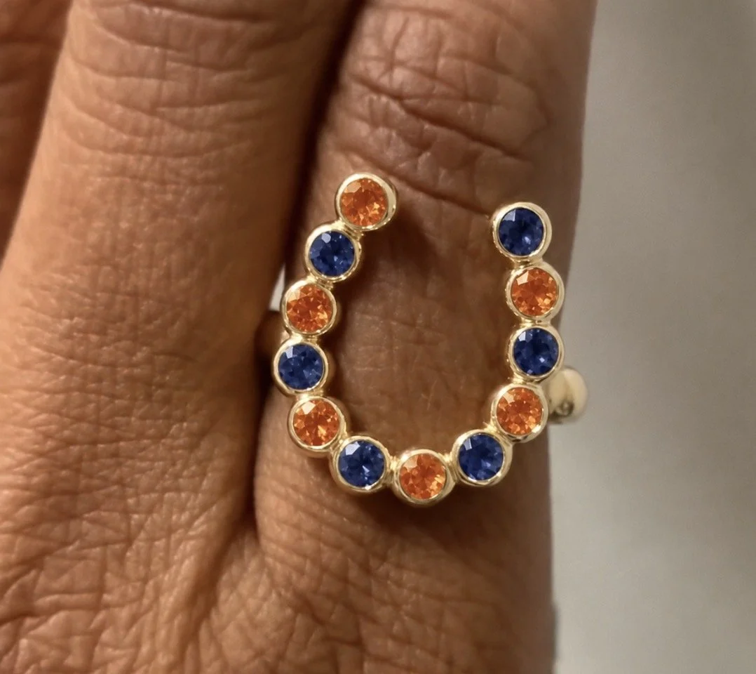 LW_orange&blue-saphires_in_18k_yeollow_gold_on_finger.jpeg