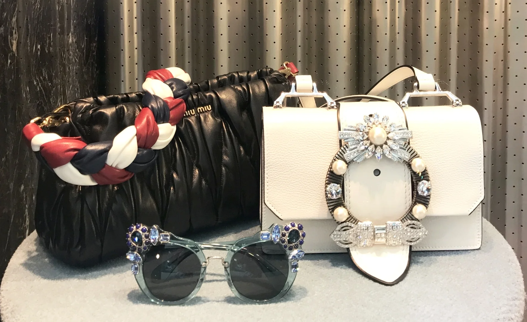 From Miu Miu, the embellished sunglasses and bag... These accessories, are the outfit... A simple dress or high neck blouse and skirt in solid colors are all that is required. It is the embellished, statement accessories that standout and should be …