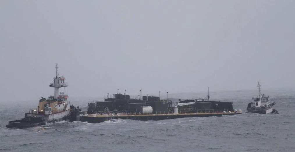 The Tug Le Cheval Rouge towing the Tug Nathan E Stewart and Barge DBL-55 on 12/19/2011. Photo Credit: US Coast Guard.