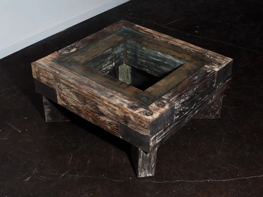 Coffee table of reclaimed materials by Adam Lam .