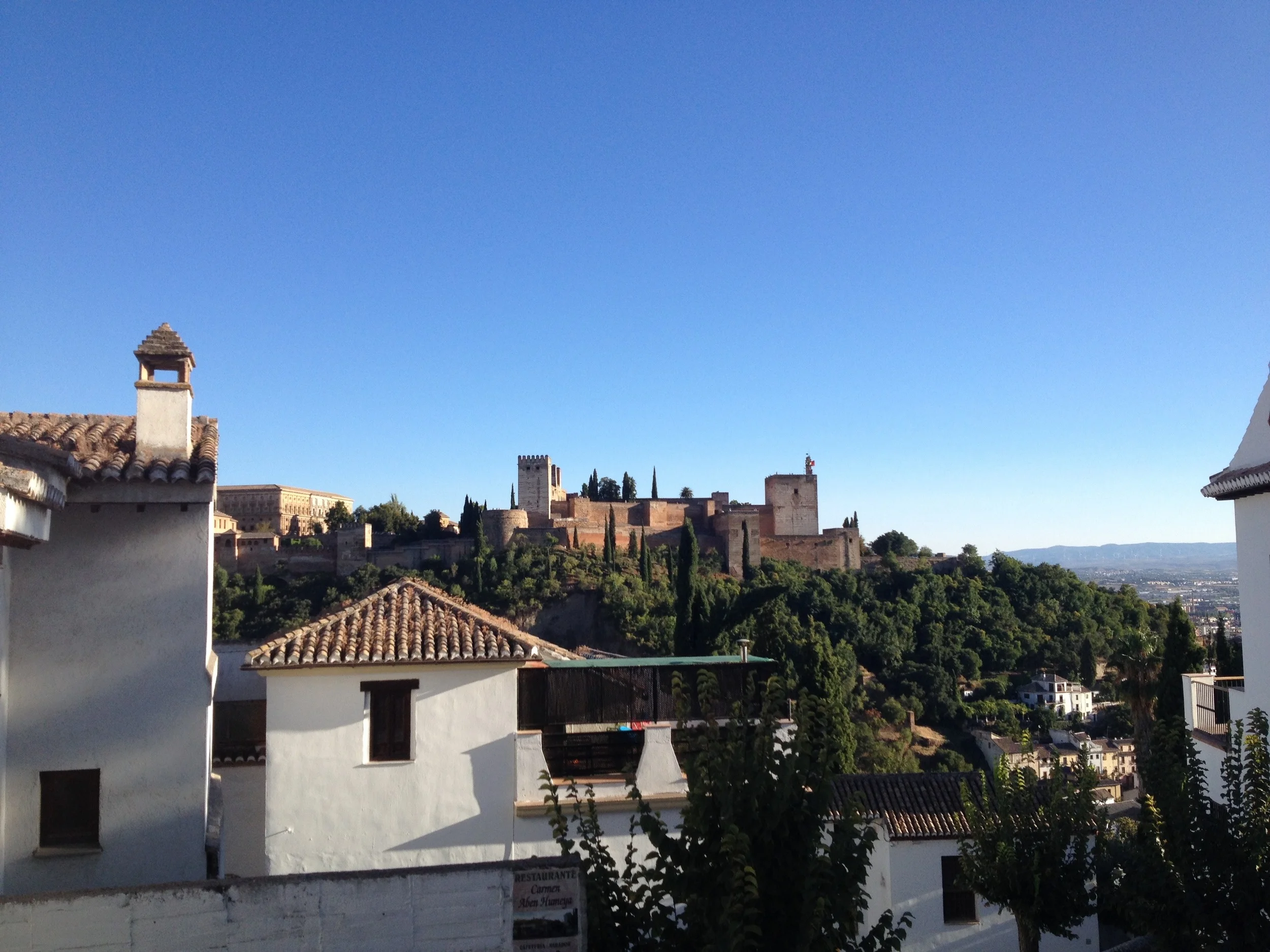 View of the Alhambra on a cloudless day from the Albaicín.