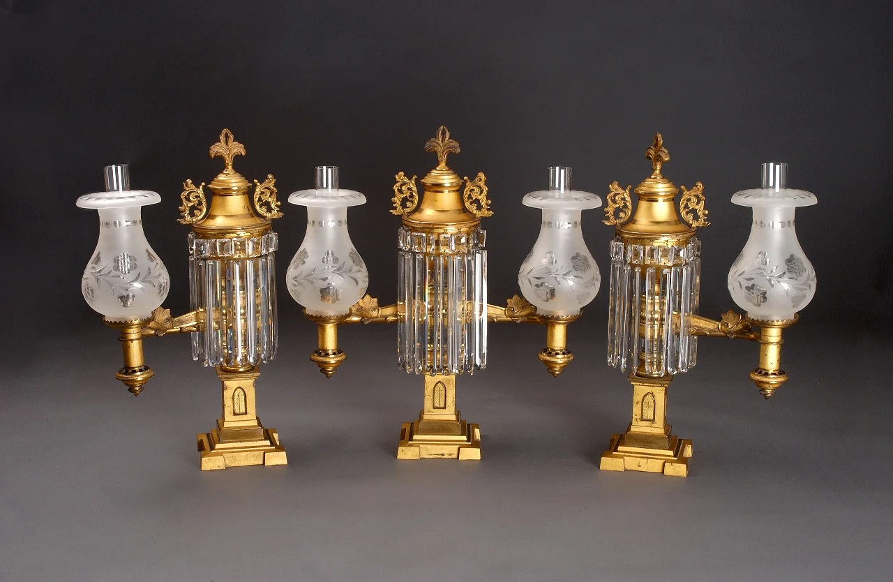 Attributed to Conrelius and Sons , Philadelphia Three-piece argand mantel garniture, c. 1845 Gilt bronze with facted prisims Center: 20 15/16 x 18 3/4 x 8 3/4 inches Side: 20 3/4 x 11 3/4 x 7 3/4 inches Side: 20 13/6 x 11 1/2 x 8 1/2 inches Gift of Mr. and Mrs. Raymond J. St. Germain, Jr. 81.33.2 a-c Photo by David Humphreys