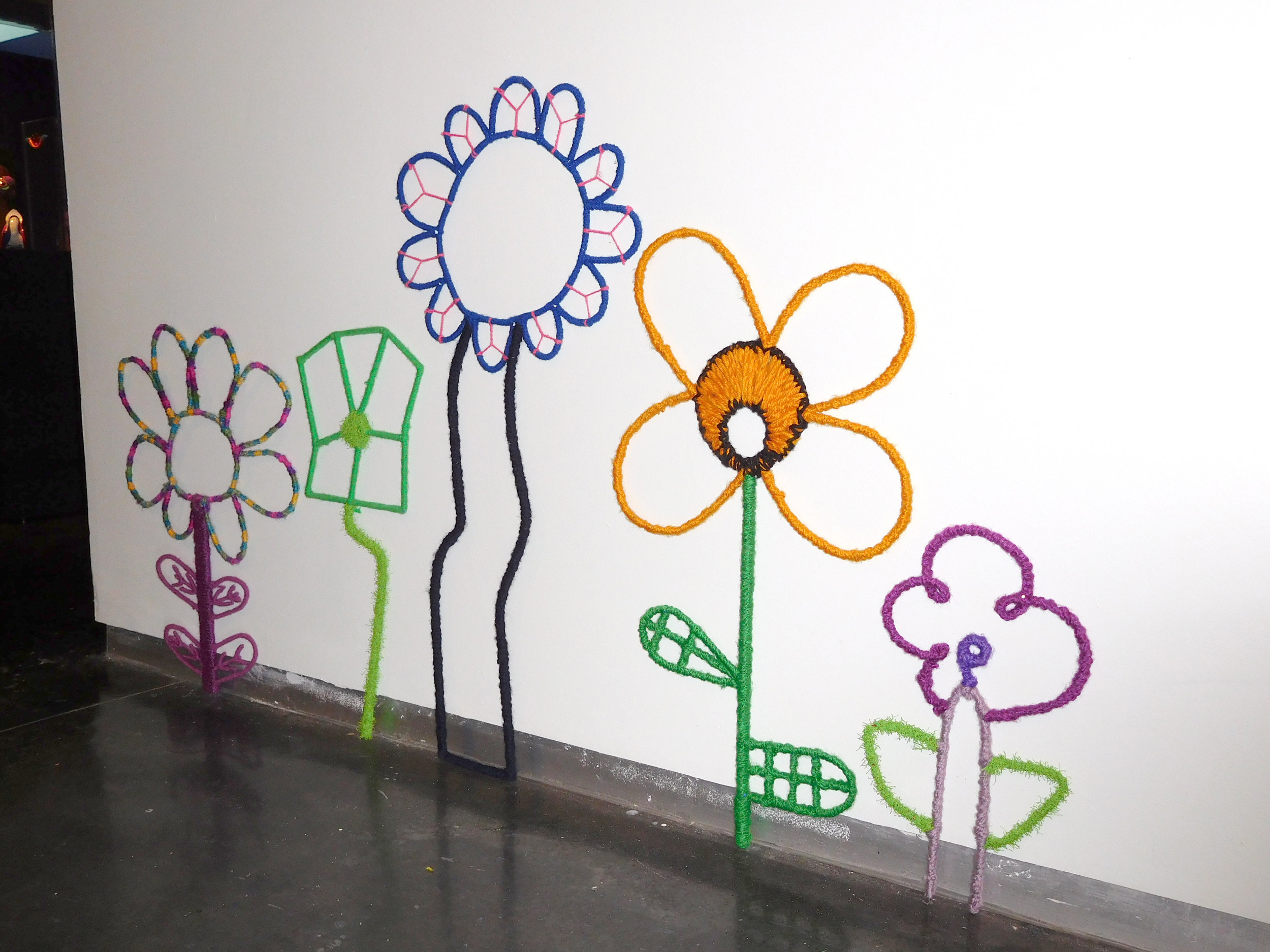 Large wired flowers made from kids' drawings