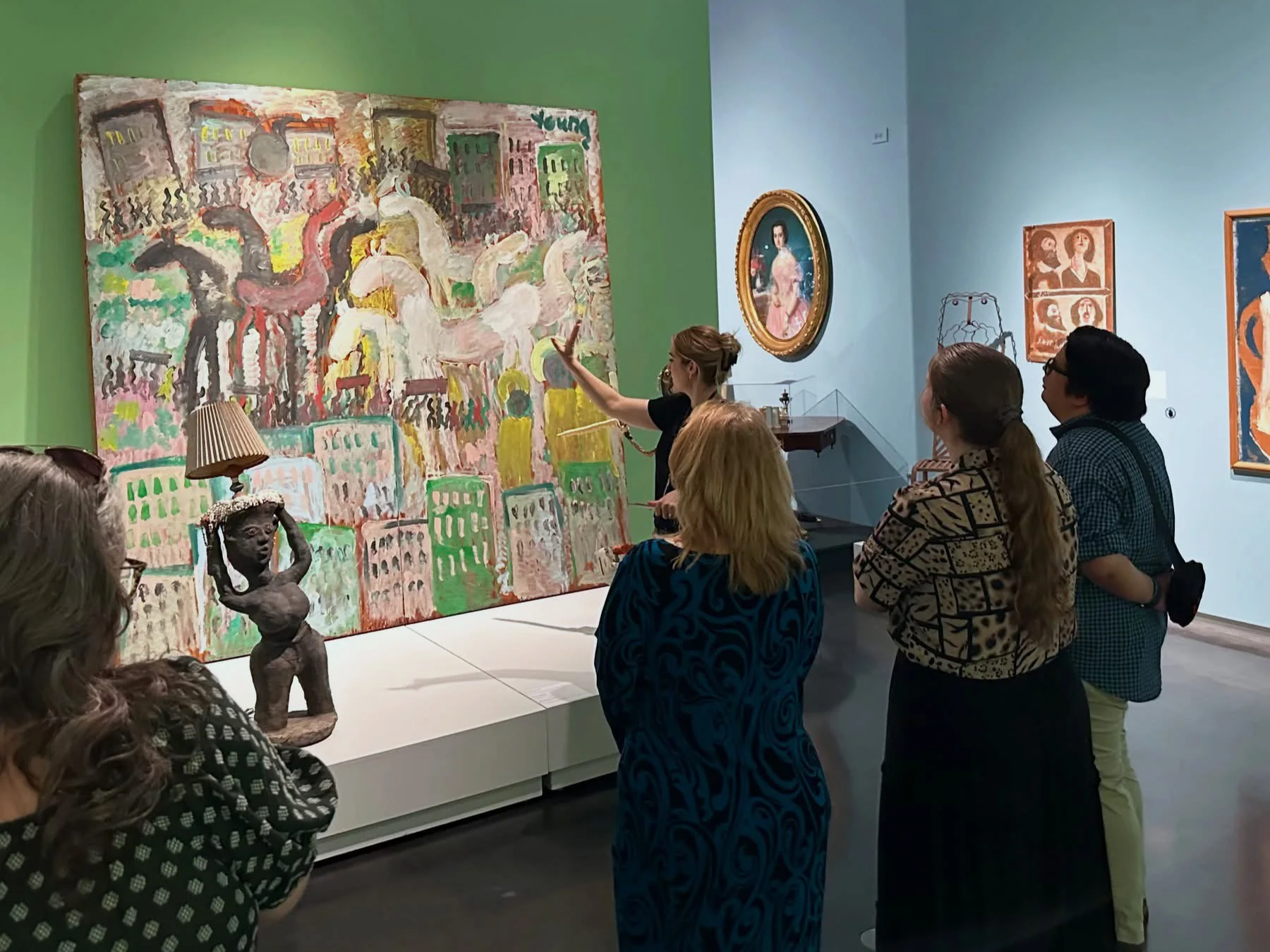Curator of Education, Callie Smith teaching in the Folk Art Gallery to a group of people.