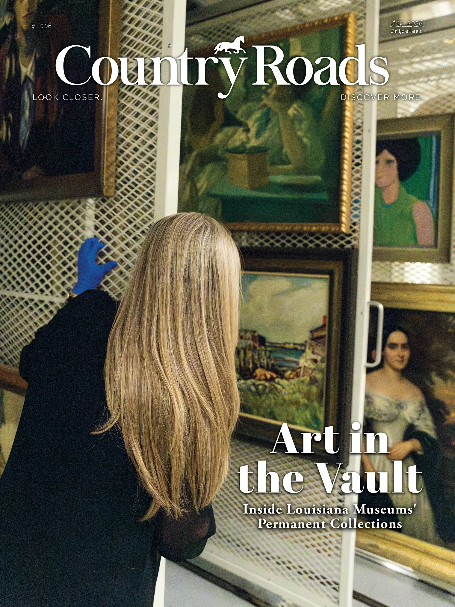 LSUMOA curator Michelle Sculte pulling out painting racks in the museum's collection on the cover of Country Roads magazine.