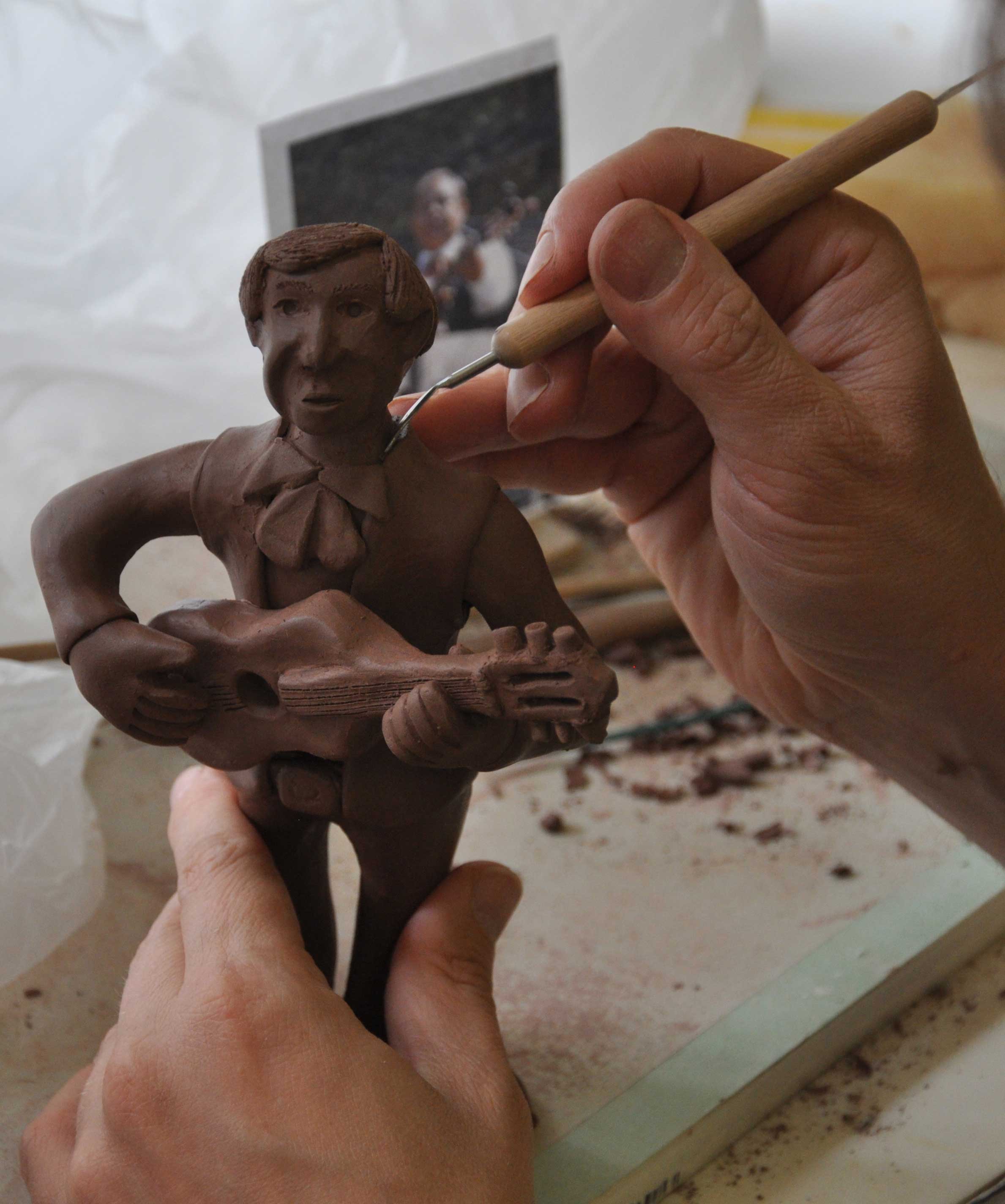  Putting the finishing touches on a Mariachi guitarist. &nbsp;The photo from the actual parade can be seen in the background. 