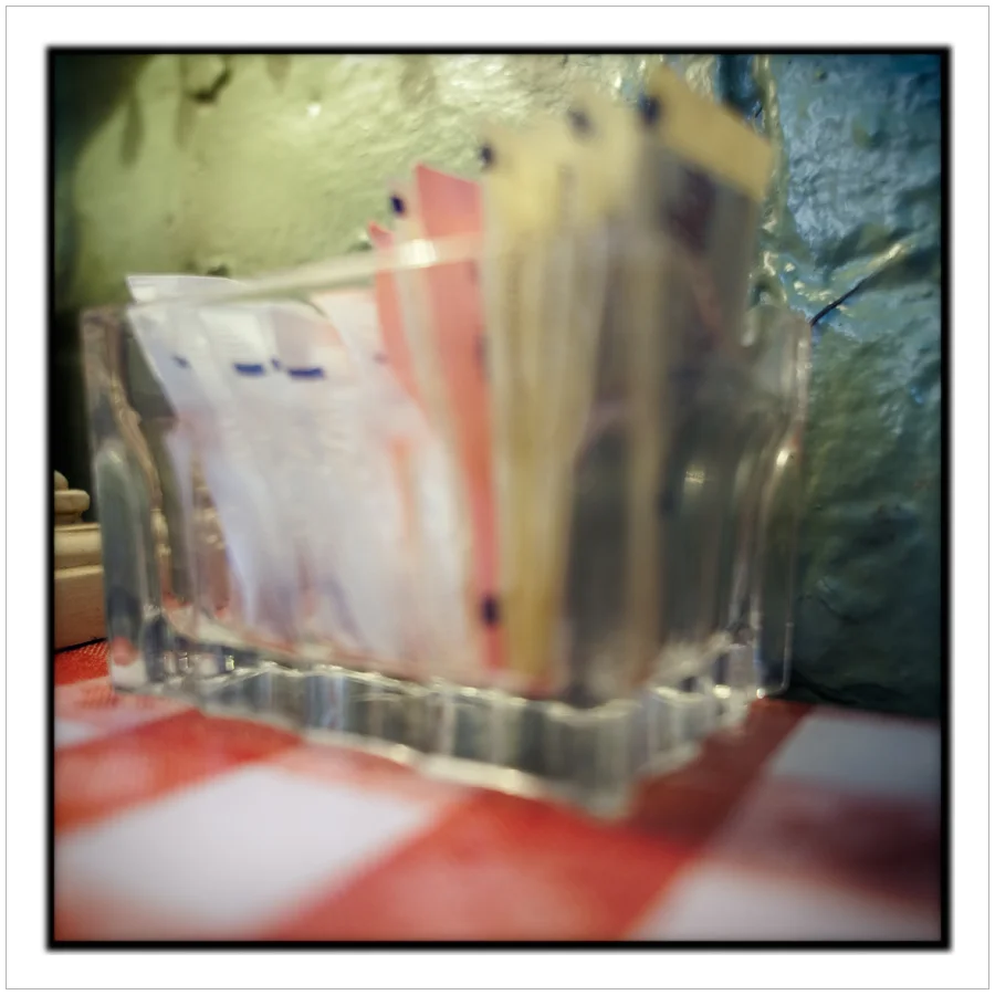 Wall crack with OOF sweetener packets / Hattie's ~ (click to embiggen)
