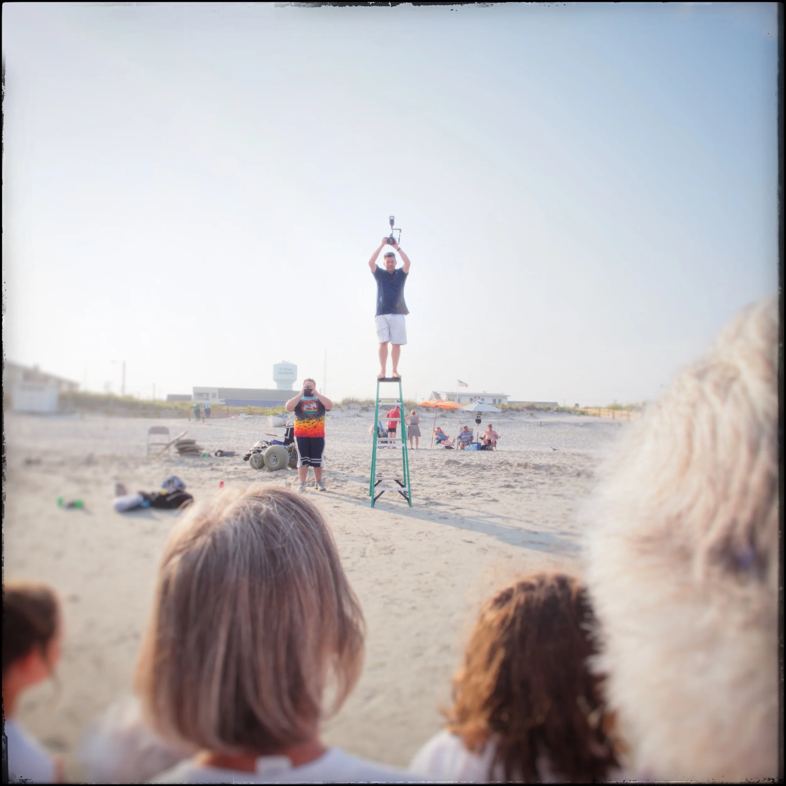 photographer taking my picture along with 100 other people/relatives/in-laws ~ Stone Harbor, NY (embiggenable) • iPhone