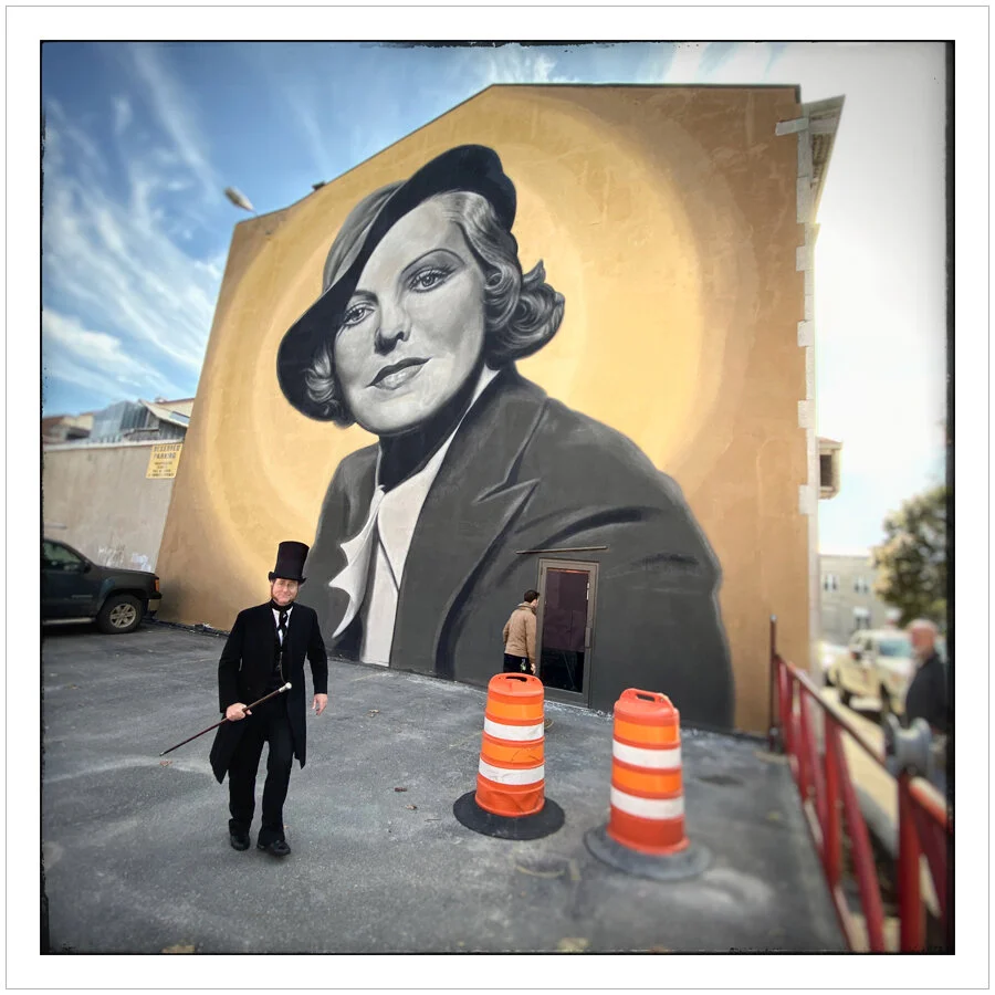 stovepipe hat guy with mural