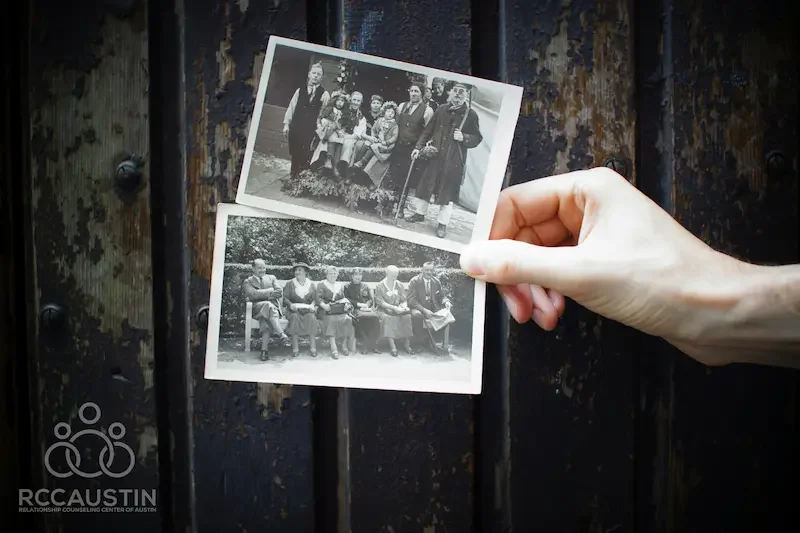 person holding two black and white family photos