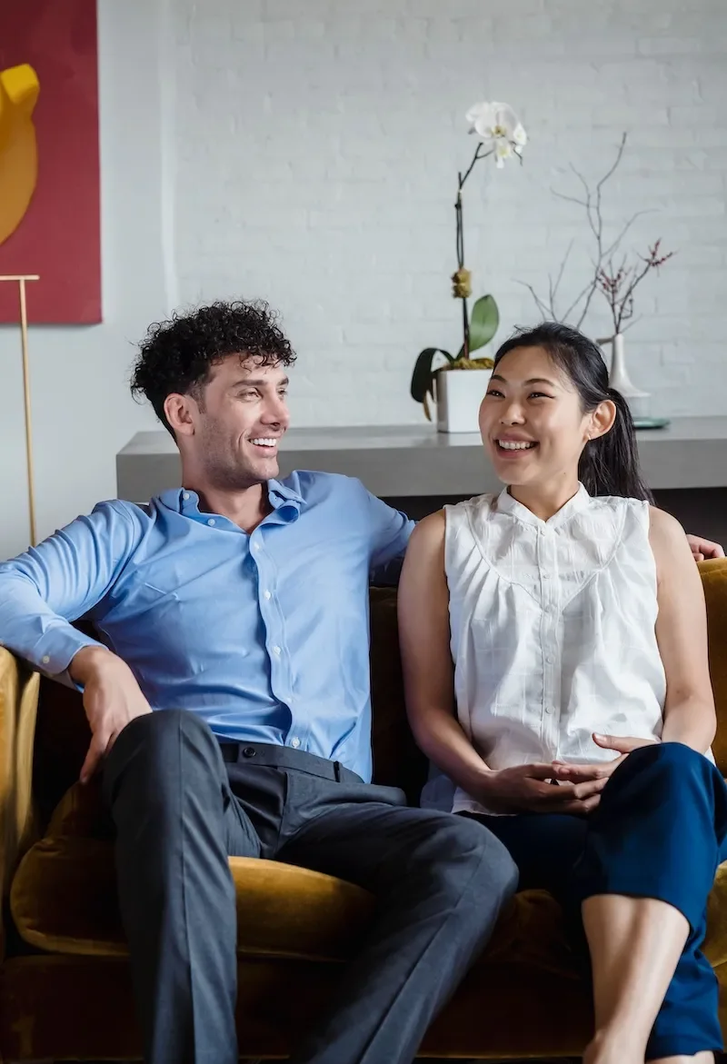 couple on sofa smiling