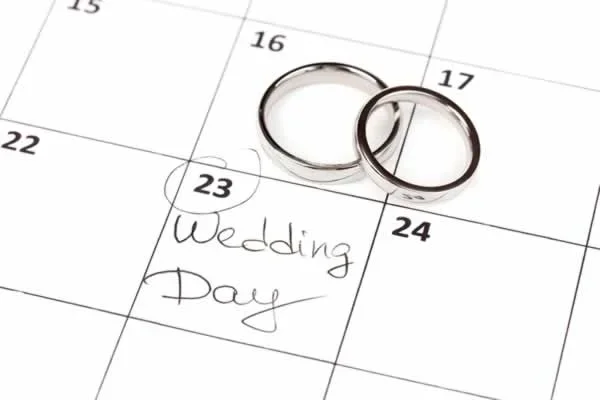 wedding rings on calendar with wedding day marked