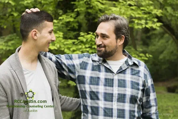 father and son smiling together