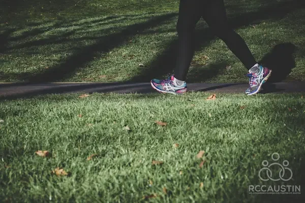 person walking on path through grass