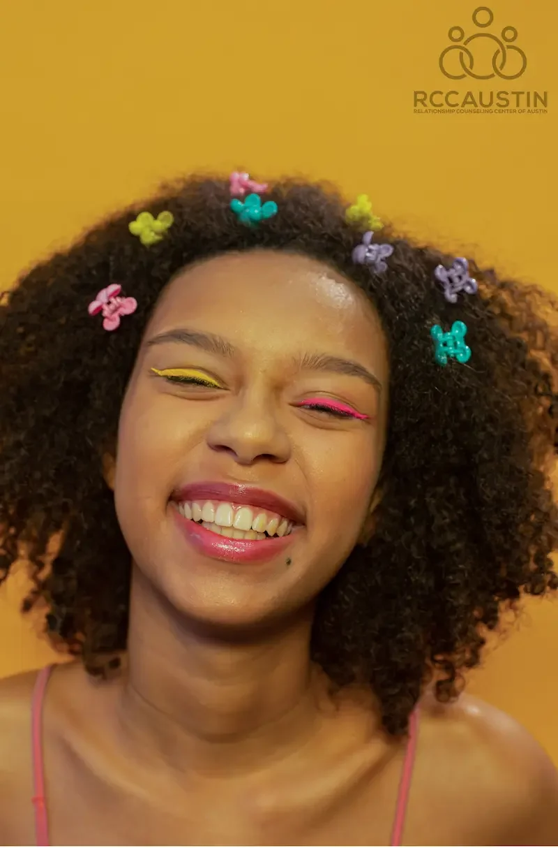 teen girl smiling with colourful makeup and clips in hair