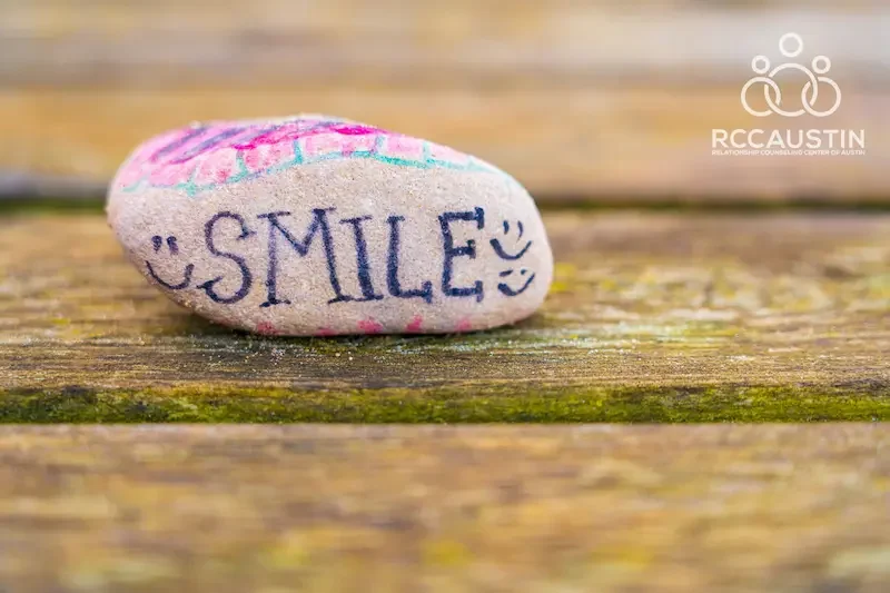 painted rock with smile written on it