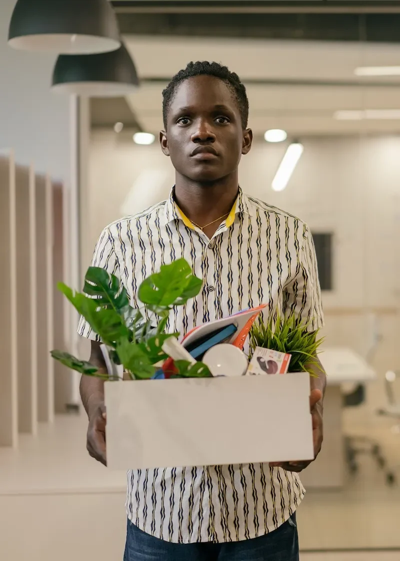 man standing with box of belongings