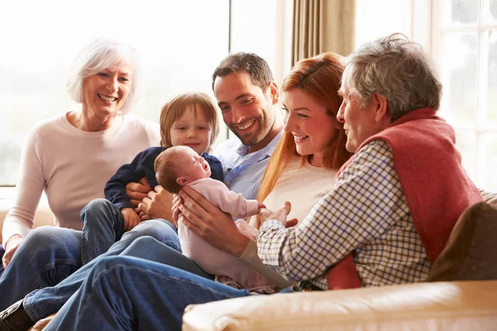 family smiling at new baby together
