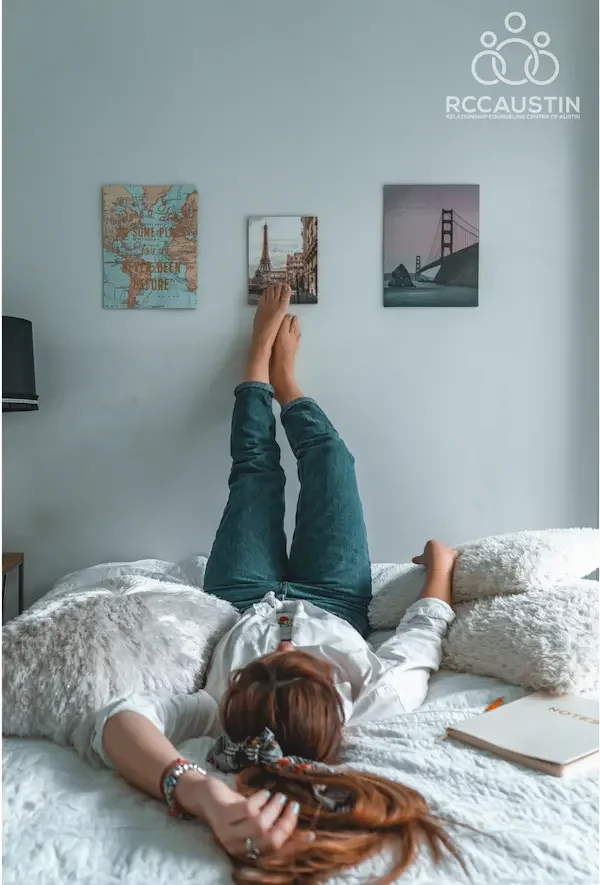 woman laying on bed with legs up wall