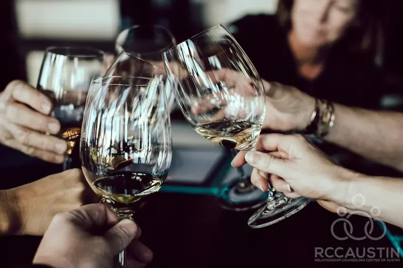 group of adults doing cheers with wine glasses