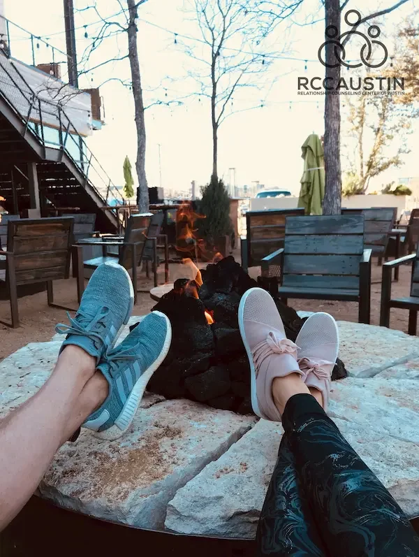 campfire with people's feet in foreground