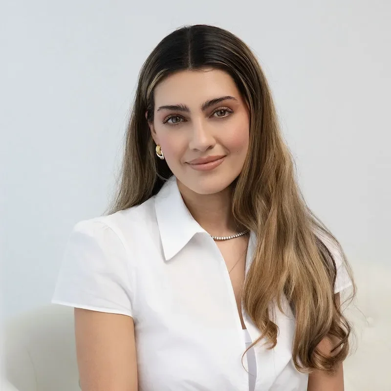 sinah travino in white blouse smiling gently