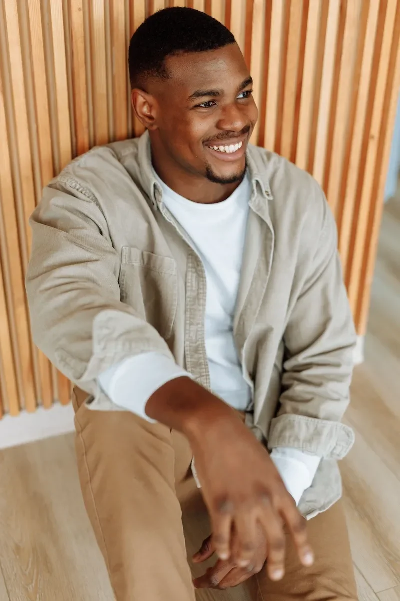 young man sitting and smiling