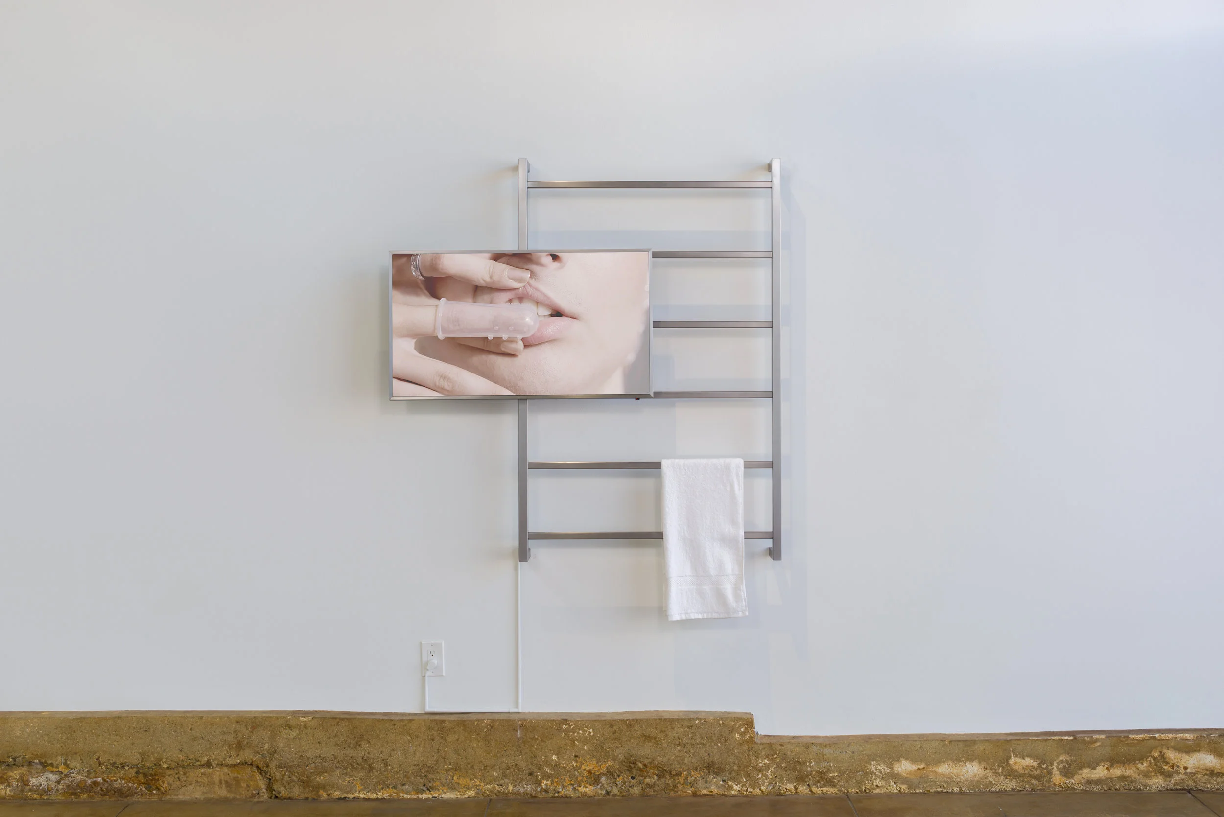 Amanda VIncelli HYGIENA 2017 Single-channel HD video, brushed steel, towel 6:11, loop, dimensions variable Ed. 5 + 2AP; Unique sculptural edition