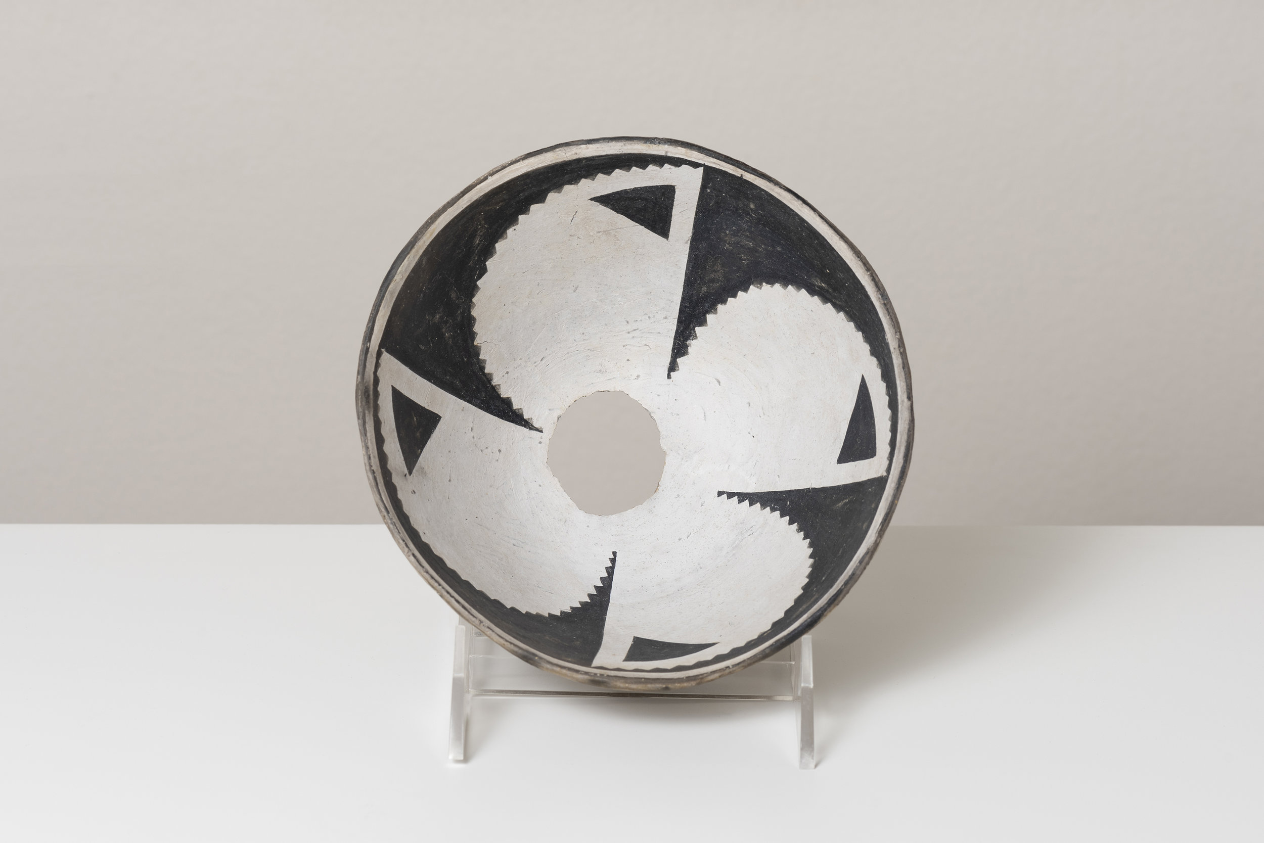   Classic Mimbres Black-on-white  Abstracted datura blossom c. 900 - 1000 CE Painted ceramic 6 inches diameter, 4 inches depth    