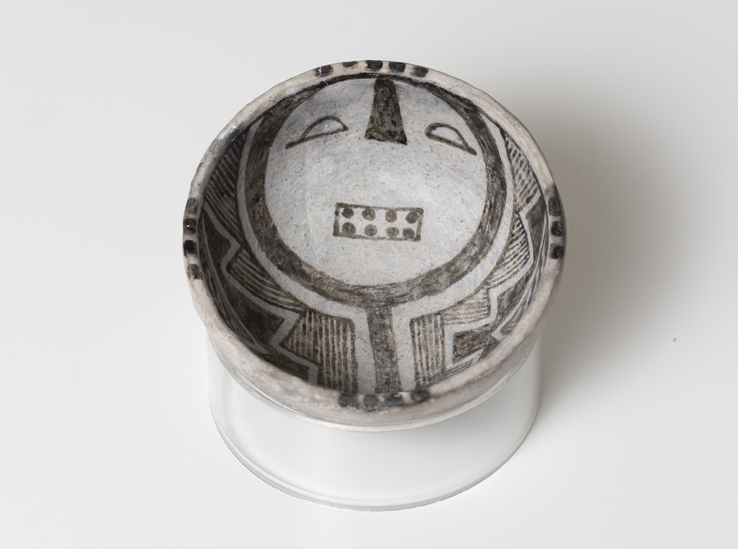   Snowflake Black-on-White  Humanoid face   c. 1175 - 1325 CE Painted ceramic 3.75 inches diameter, 2 inches depth    