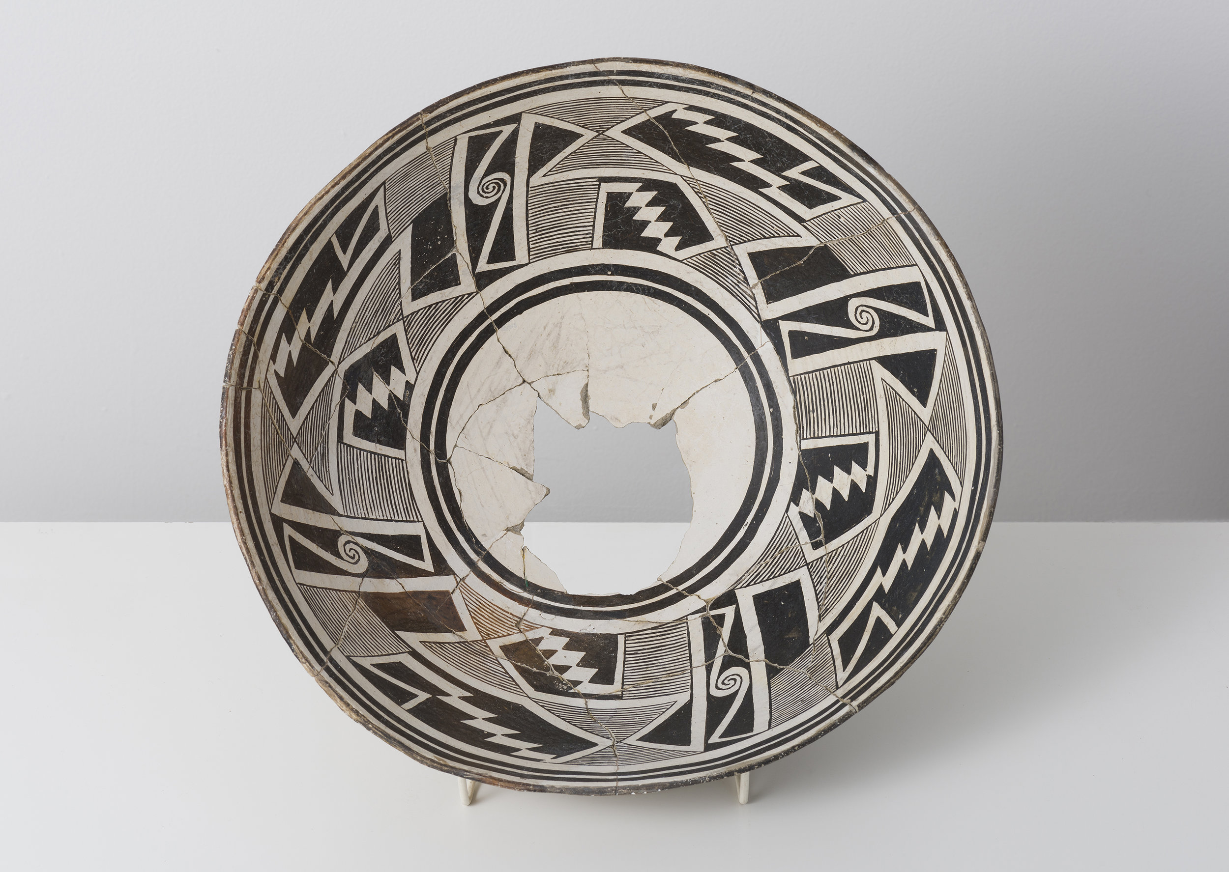   Classic Mimbres Black-on-white  Abstracted datura buds with entoptic patterns c. 900 - 1000 CE Painted ceramic 13 inches diameter, 4 inches depth    