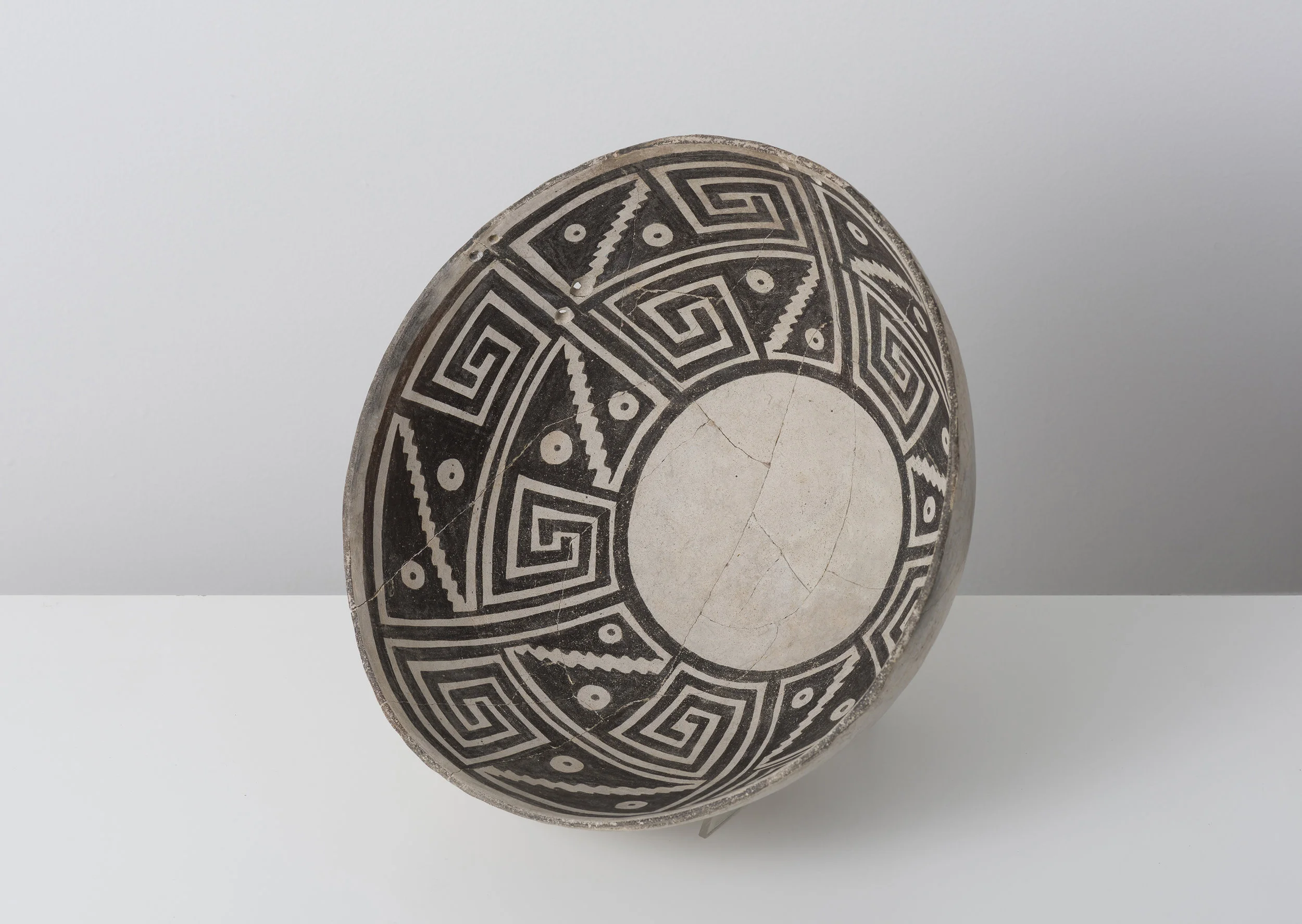 Classic Mimbres Black-on-white Abstracted hawk moth proboscis / datura blossom c. 900 - 1000 CE Painted ceramic 12 inches diameter, 4 inches depth