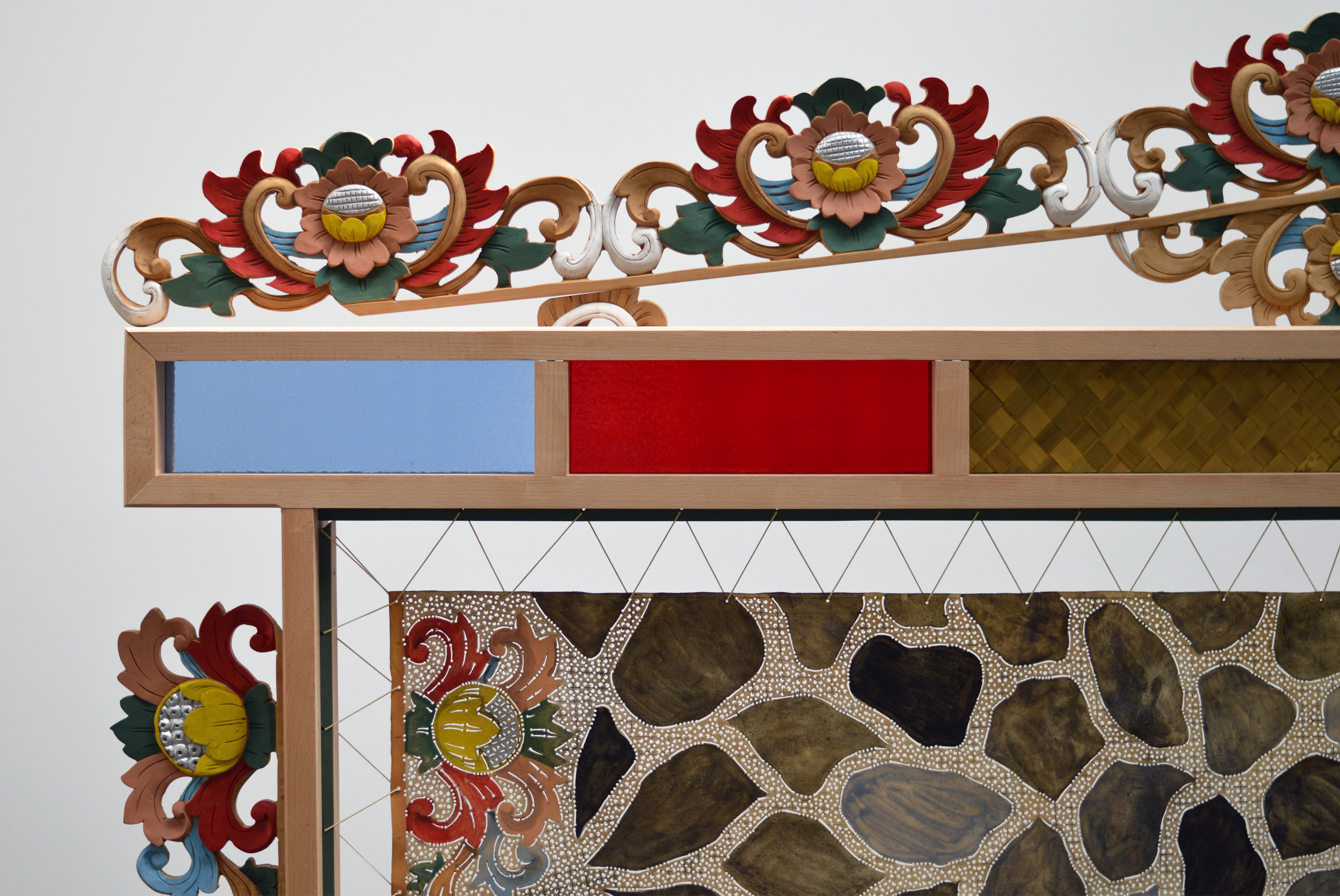   Adam de Boer      Room Screen for Mohawk Street  (detail)    2018 acrylic paint on hand carved hides, acrylic paint on hand carved teak, stained glass, and woven pandan leaf 74 x 96 x 16 inches    