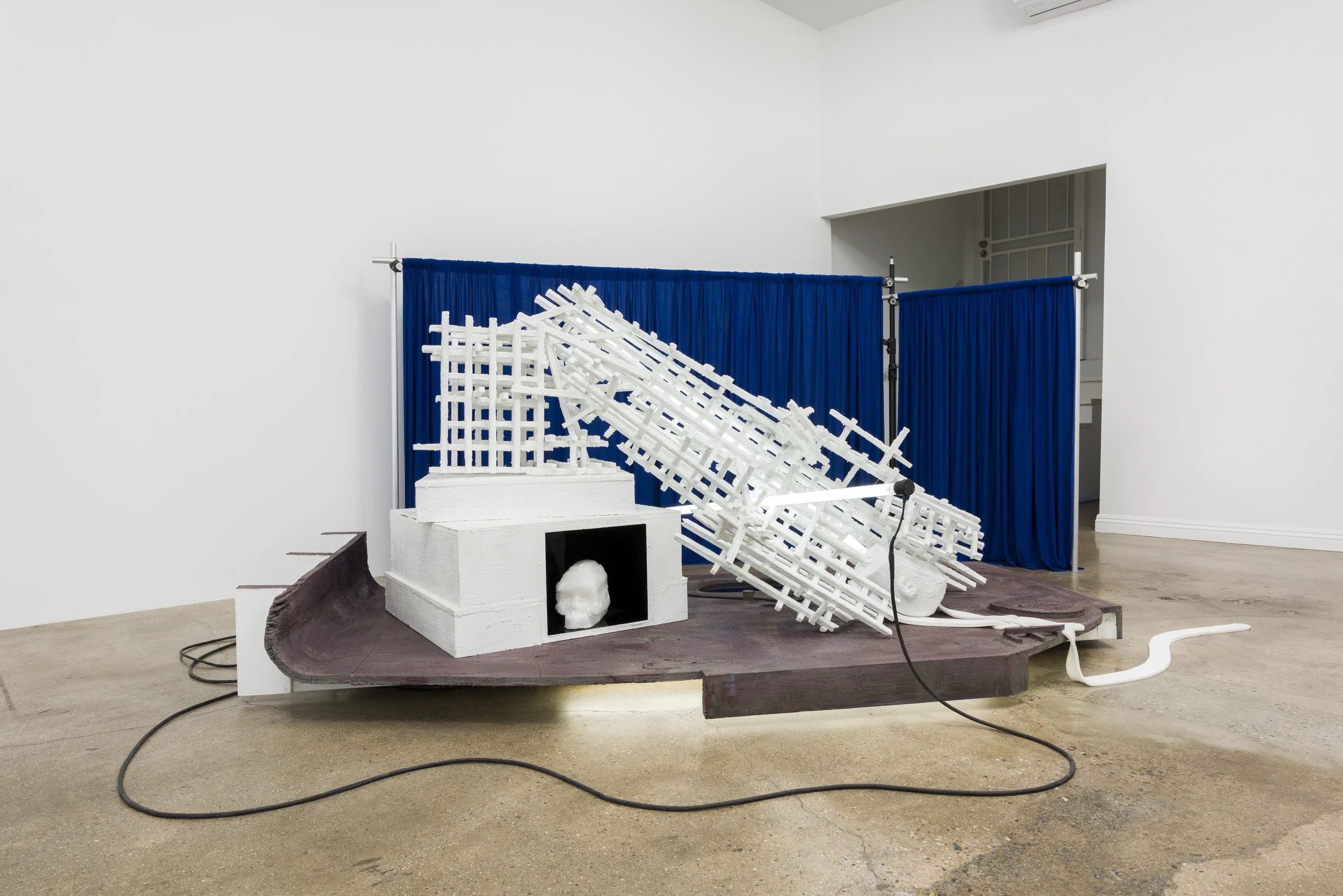 Don Edler Learning from Monuments (Durham, NC August 14, 2017 ) 2016-2019 Lumber, plywood, black mirror, fluorescent lights, auto paint, petroleum wax, Crayola wax, platinum silicone, techno scuba fabric, light stand, aluminum pipe, couplers, cables Dimensions variable Photo by Ruben Diaz
