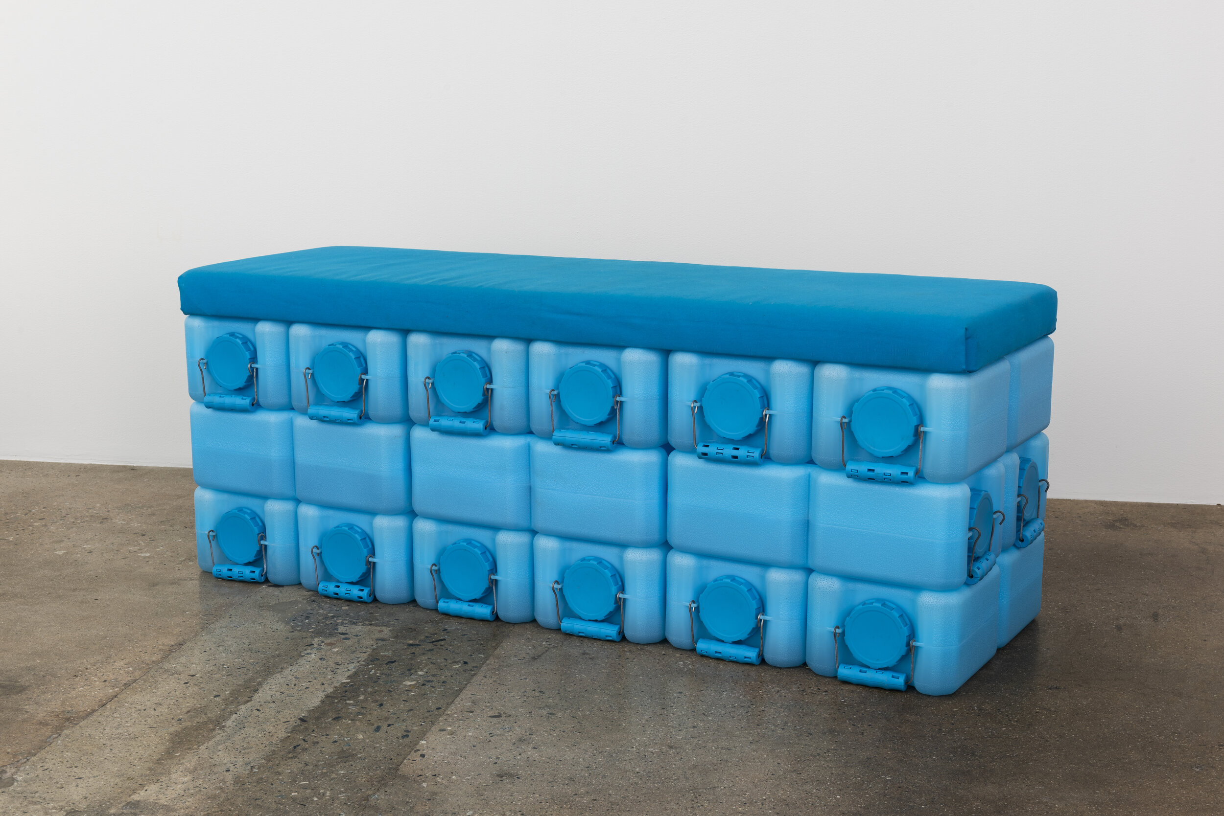   Colleen Hargaden   Water Brick (Bench)  2019 Water bricks, water, handmade upholstered panels 18 x 54 x 21 inches  Photo by Ruben Diaz 